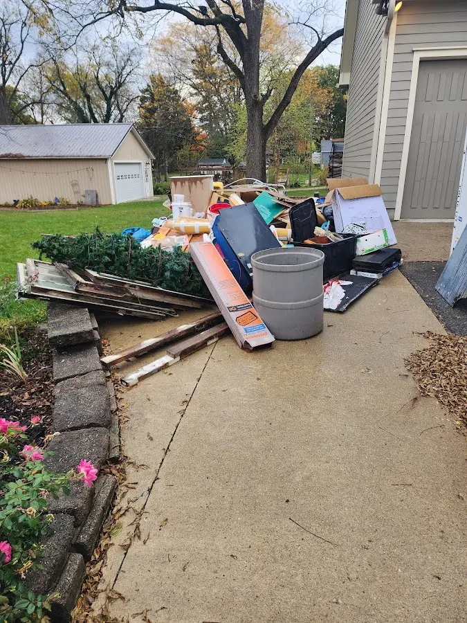 Dumpster being loaded with debris for Commercial Dumpster Rental in Tiverton